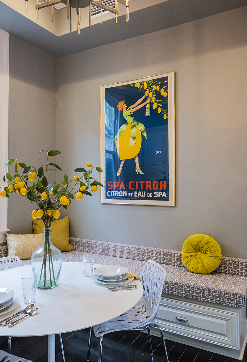 Bright and Cheery Breakfast Nook with built in storage, yellow throws, lemon centerpiece